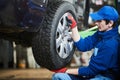 Auto service. Worker screwdriving an automobile wheel. Break maintenance or tyre replace Royalty Free Stock Photo