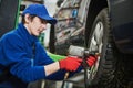 Auto service. Worker screwdriving an automobile wheel. Break maintenance or tyre replace Royalty Free Stock Photo