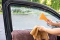 Using squeegee blade cleaning old car window film tint