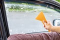 Using squeegee blade cleaning old car window film tint
