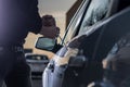 Auto thief in black balaclava trying to break into car Royalty Free Stock Photo