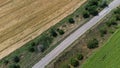 Auto track running through wheat and sunflower fields aerial photography Royalty Free Stock Photo