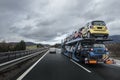 Auto transporter laden by small cars is on the highway Royalty Free Stock Photo