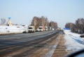 Auto trucks length gages go on Minskoye Highway in the winter clear morning.