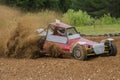 Autocross on a dusty road. Car in competition up the road on a d