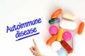 Autoimmune disease on white background near colorful pills or drugs