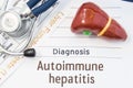 Autoimmune hepatitis diagnosis. Anatomical 3D model of human liver is near stethoscope, results of laboratory tests of liver funct