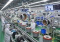 Automated assembly line in a high-tech factory setting. Workers in white protective suits and blue Royalty Free Stock Photo