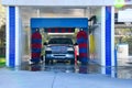 Automated car wash with a soapy truck Royalty Free Stock Photo
