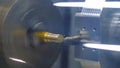 Automated CNC lathe machine cutting rotating metal workpiece - close up