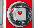 Automated external defibrillator, or AED, with its international symbol hanging in a public place. Royalty Free Stock Photo