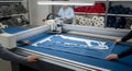 Automated Fabric Cutting Process in Industrial Setting with Precision and Teamwork Blue Textile Materials and Modern Technology Royalty Free Stock Photo