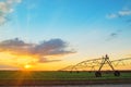 Automated farming irrigation system in sunset Royalty Free Stock Photo