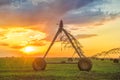 Automated farming irrigation system in sunset Royalty Free Stock Photo