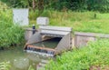 Automated working small weir in a Dutch polder ditch Royalty Free Stock Photo