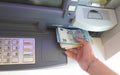Atm and banknotes in euro and the hand Royalty Free Stock Photo