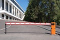 Automatic barrier at the entrance to the parking lot near the public building Royalty Free Stock Photo