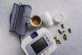 Automatic blood pressure meter and pills, coffe. High blood pressure concept Royalty Free Stock Photo