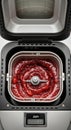 Automatic bread maker mixing fresh strawberry jam in stainless steel container with digital display Royalty Free Stock Photo