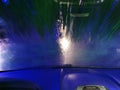 Automatic Car Wash Process. Spray foam bubble shampoo on the car surface. Car wash view from the salon Royalty Free Stock Photo