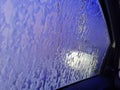 Automatic Car Wash Process. Spray foam bubble shampoo on the car surface. Car wash view from the salon Royalty Free Stock Photo