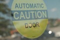 automatic caution door symbol on glass automatic door in circle, yellow black. p