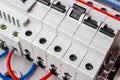 Automatic circuit breakers on DIN rail closeup in the white plastic mounting box Royalty Free Stock Photo