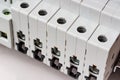 Automatic circuit breakers with disconnected ports installed on DIN rail in the white plastic mounting box closeup Royalty Free Stock Photo