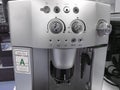 Automatic coffee machines at exhibition on white kitchen background Royalty Free Stock Photo