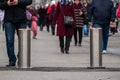 Automatic cylindrical barriers on the pedestrian zone against the background of blurry feet of pedestrians