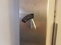 Automatic deadbolt turn to engage privacy sign on interior door