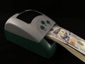 Automatic detector for checking banknotes. Dollars are checked through the device. One hundred dollar bills and a machine for Royalty Free Stock Photo