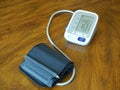 Automatic digital blood pressure monitor on wood table Royalty Free Stock Photo