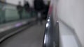 Automatic escalator in a mall, a crowd of people coming down Royalty Free Stock Photo