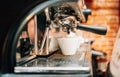 Automatic espresso machine preparing fresh arabic coffee into cup