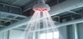 Automatic fire sprinkler system sprays water in building. Water spreads from ceiling in case of fire. Fire suppression system in Royalty Free Stock Photo