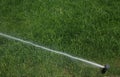 Automatic Garden Lawn sprinkler in action watering green grass Royalty Free Stock Photo