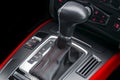 Automatic gear stick with red stich of a modern car. Car interior details. Dashboard with buttons. Royalty Free Stock Photo