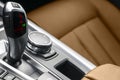 Automatic gear stick transmission of a modern car. Multimedia and navigation control buttons. Car interior details. Transmission s Royalty Free Stock Photo