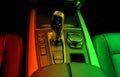 Automatic gear stick transmission of a modern car in red and green tones. multimedia and navigation control buttons. Car Royalty Free Stock Photo