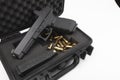 Automatic gun and bullets in a plastic hard case on white background Royalty Free Stock Photo
