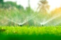 Automatic lawn sprinkler watering green grass. Sprinkler with automatic system. Garden irrigation system watering lawn. Water Royalty Free Stock Photo