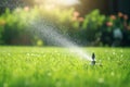 Automatic lawn sprinkler watering green grass. Sprinkler with automatic system. Garden irrigation system watering lawn. Water Royalty Free Stock Photo