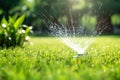 Automatic lawn sprinkler watering green grass. Sprinkler with automatic system. Garden irrigation system watering lawn. Water Royalty Free Stock Photo