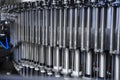 Automatic line for filling beer and water into plastic bottles. Industrial production of beverages. Capping machine. Royalty Free Stock Photo