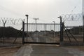 Automatic metal gate. Barbed wire fence block the way. gate to a closed area