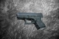 Automatic 9mm. handgun pistol on cement wall background Royalty Free Stock Photo