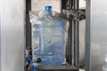 Automatic packaging of plastic bottles with clean drinking water in plastic or cellophane bag in factory Royalty Free Stock Photo