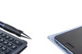 Automatic pen, calculator, notebook, phone on a white background close-up. Royalty Free Stock Photo