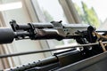 Automatic rifle on stand on the table of the weapons workshop. Royalty Free Stock Photo